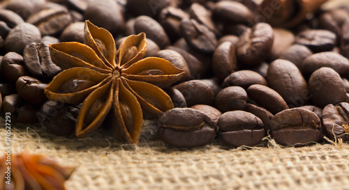 coffee beans and star anise on coarse fabric
