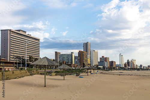 Early Morning Beach Against City and Blue Cloudy Skyline © lcswart