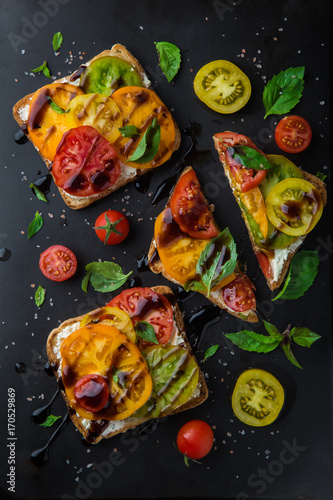 colorful tomatoes sandwich with basil and basamic vinegar