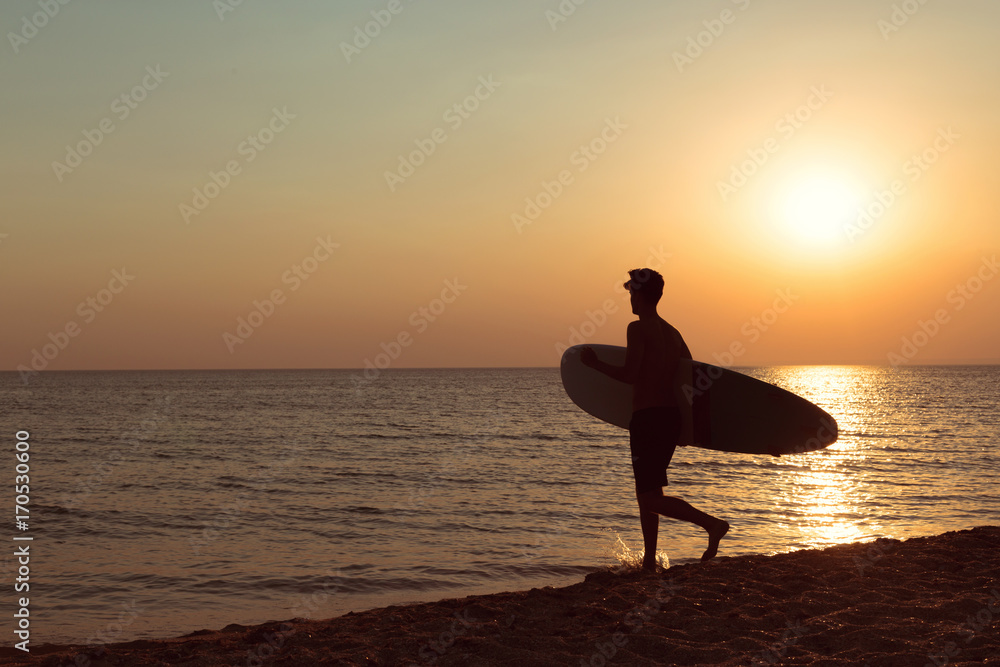 A surfer at sunset.