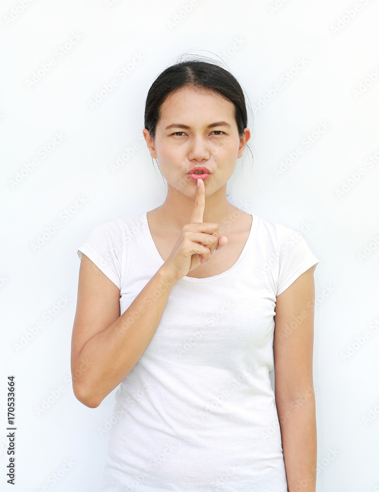 Young asian woman in T-Shirt Showing expression the silence sign. Young asian woman in T-Shirt Showing expression the silence sign.