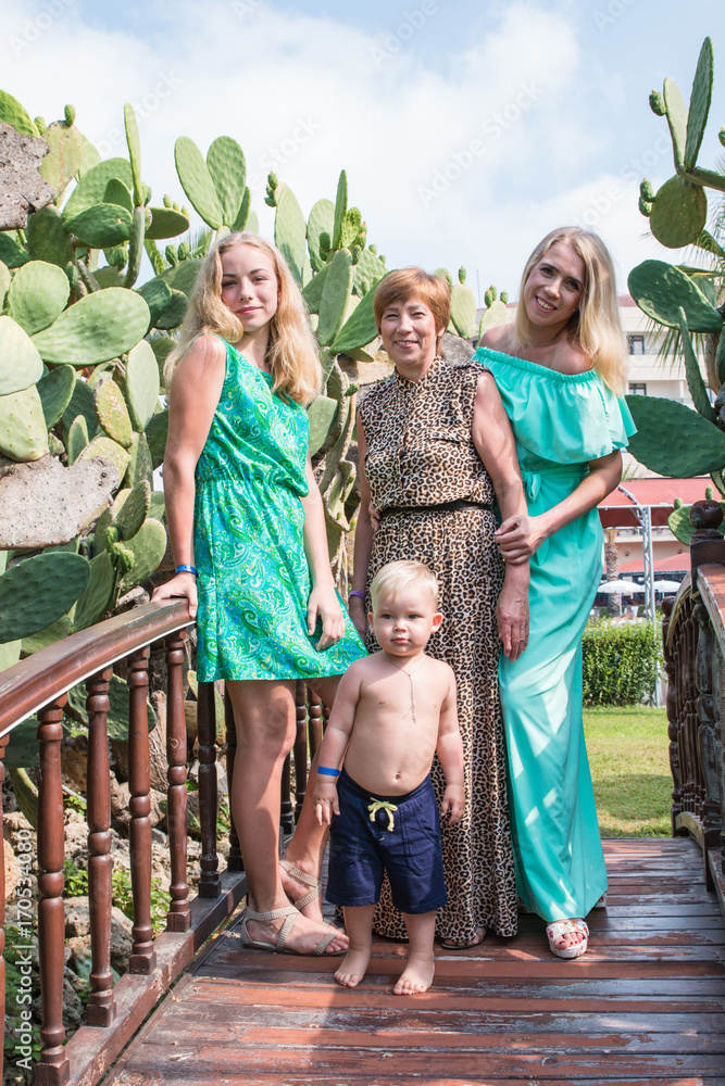 Naklejka premium Family includes grandmother, mother, girl and boy in the Park