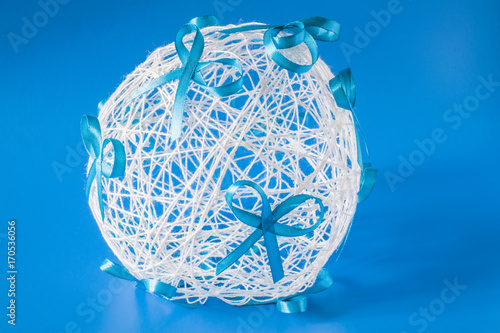 wedding ball with bows on a blue background of threads photo