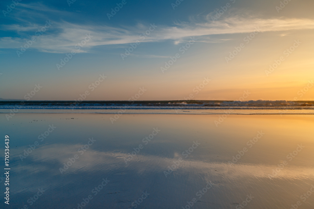 Sunset at Cuta Beach, Bali with beautiful mirror reflection