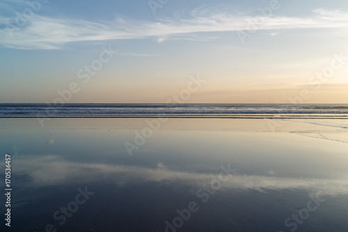 Sunset at Cuta Beach, Bali with beautiful mirror reflection © Sokirlov