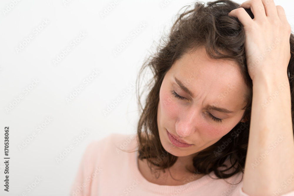 Young woman having a headache due to stress and anxiety - Burn out concept Young woman having a headache due to stress and anxiety - Burn out concept