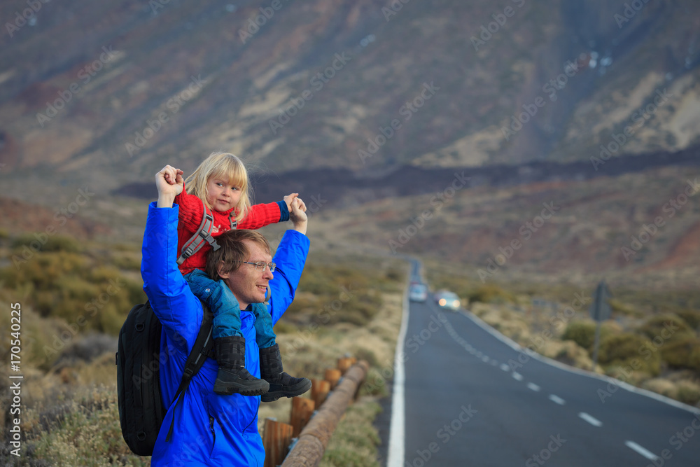 father with little daughter travel in mountains
