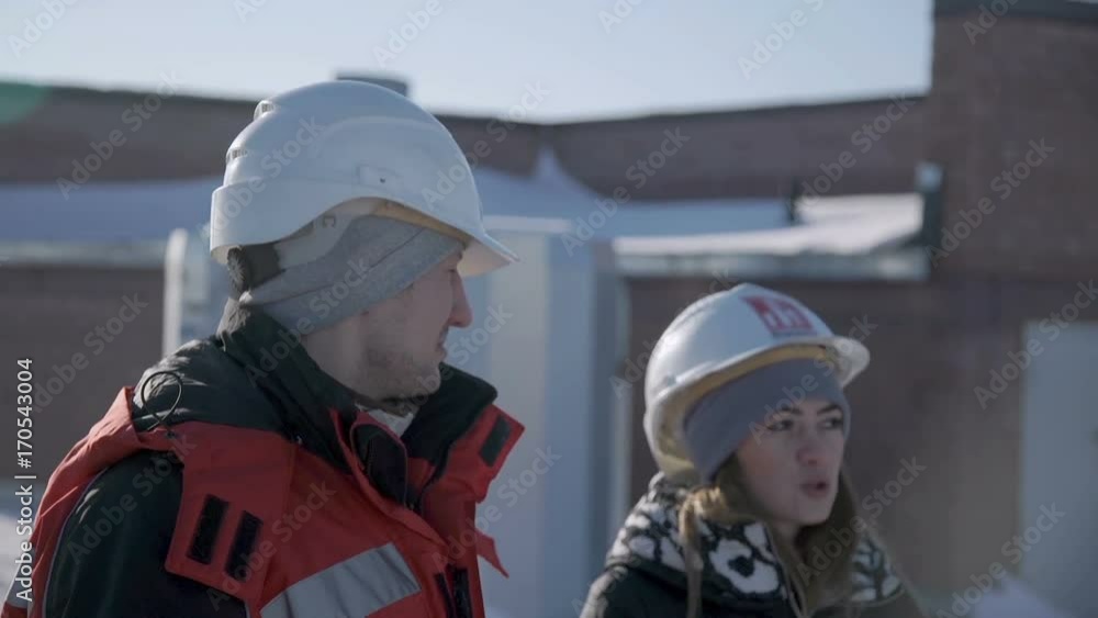 Man explains something to a woman and looks at the camera close up Man explains something to a woman and looks at the camera close up