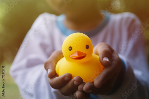 Boy holding yellow rubber duck