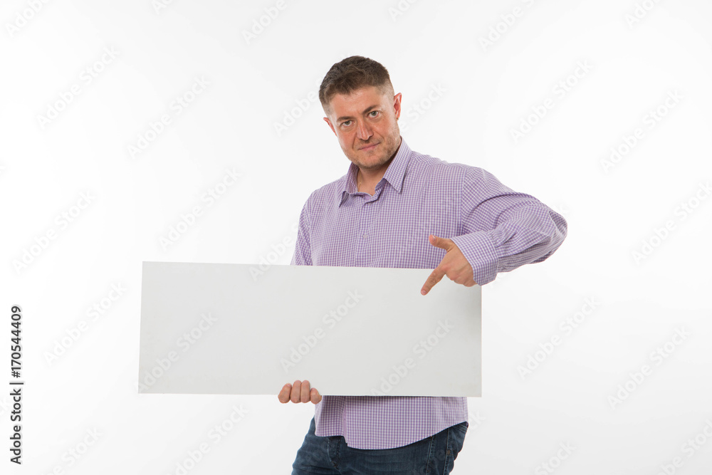 Young confident man portrait of a confident businessman showing presentation, pointing paper placard gray background. Ideal for banners, registration forms, presentation, landings, presenting concept. Young confident man portrait of a confident businessman showing presentation, pointing paper placard gray background. Ideal for banners, registration forms, presentation, landings, presenting concept.