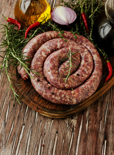raw beef sausages on a cast-iron pan, selective focus
