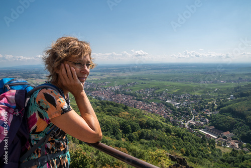 A short break at a vantage point in France; woman looks at Ribeauville in the Vosges 