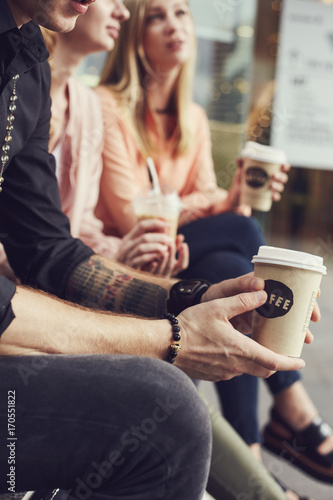 Young adult student people outside in the city drinking coffee and chatting together © Photo-maxx