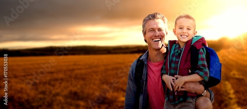 Composite image of portrait of a crouching father beside son  © vectorfusionart