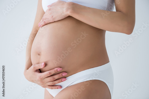pregnant woman touching belly