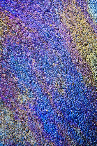 Metallic Rainbow Petrol Spill on Pavement Sidewalk © squeebcreative