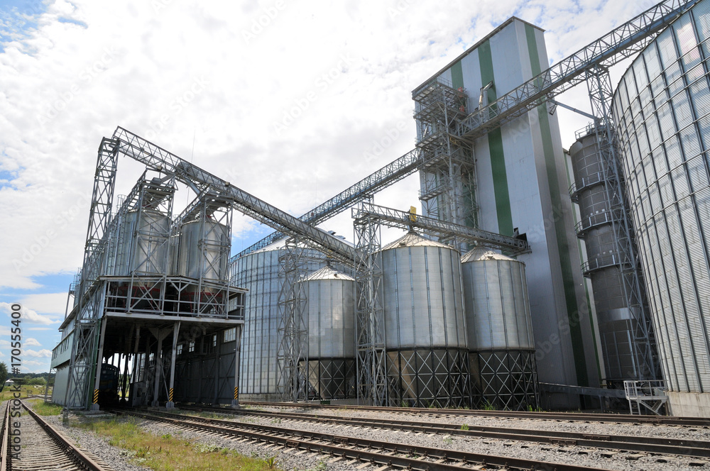 Naklejka premium Agricultural Silos. Metal grain facility with silos.