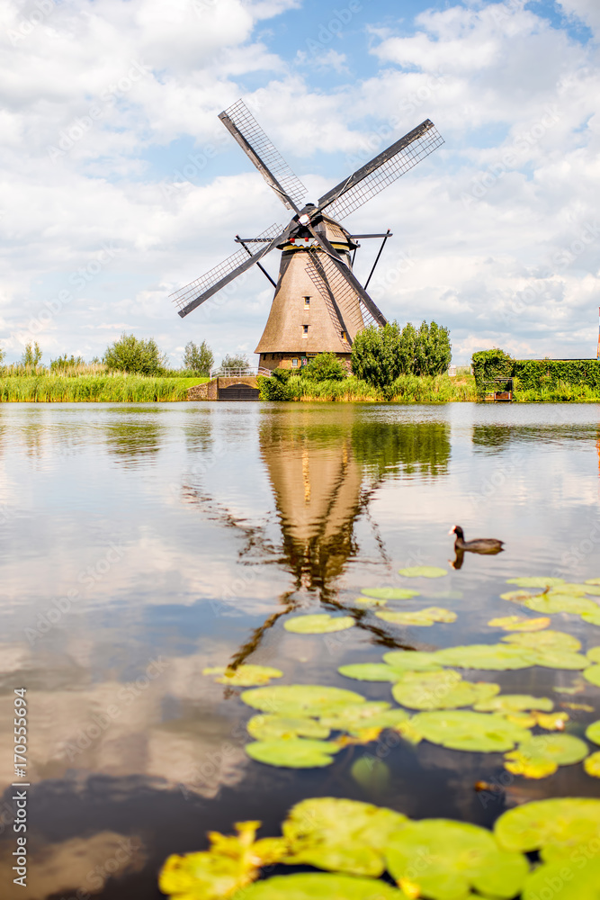 Landscape view on the old windmills during the sunny weather in Kinderdijk village, Netherlands