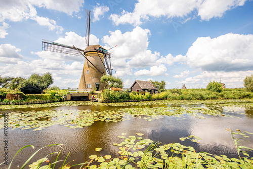 Landscape view on the old windmills during the sunny weather in Kinderdijk village, Netherlands