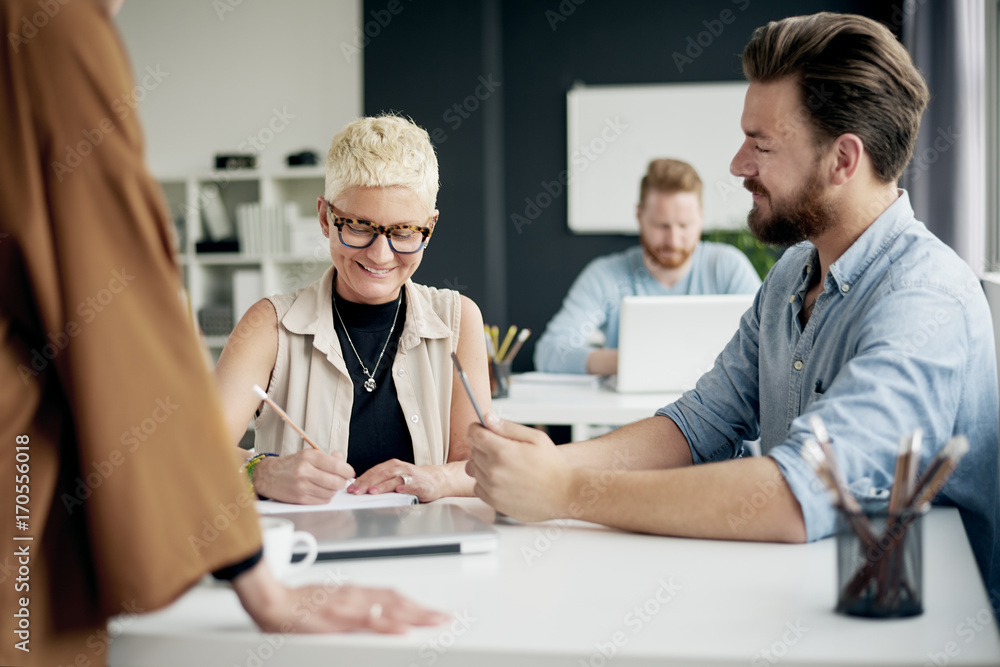 Multi ethnic team having meeting or presentation in modern office Multi ethnic team having meeting or presentation in modern office