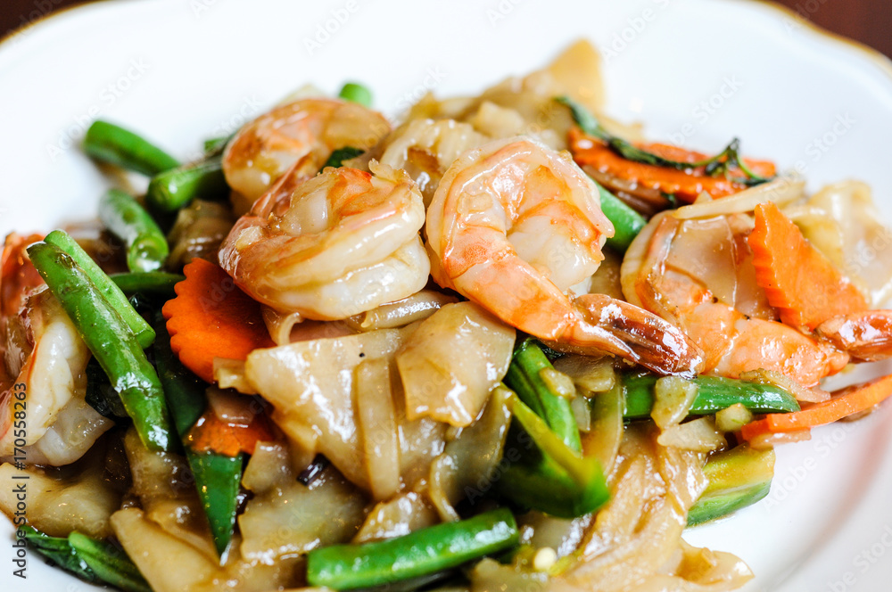 Pad Khee Mao, Stir-fried with wide rice noodles, hot peppers, carrots, green beans, onions, tomato and sweet basil leaves. Pad Khee Mao, Stir-fried with wide rice noodles, hot peppers, carrots, green beans, onions, tomato and sweet basil leaves.