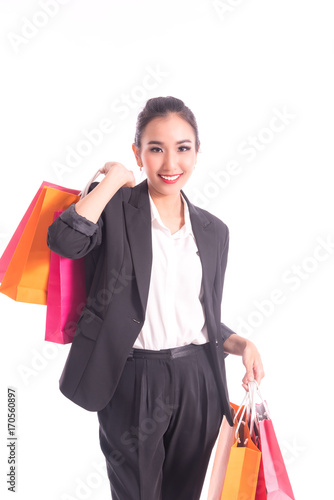 Cheerful shopping woman of Asian holding bags. Shopping smart business woman happy smiling holding colorful shopping bags isolated on white . Fresh young Asian female model
