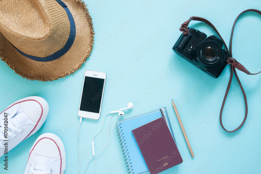 Flat lay of travel items with mobile device, passport and camera on pastel color background - obrazy, fototapety, plakaty 
