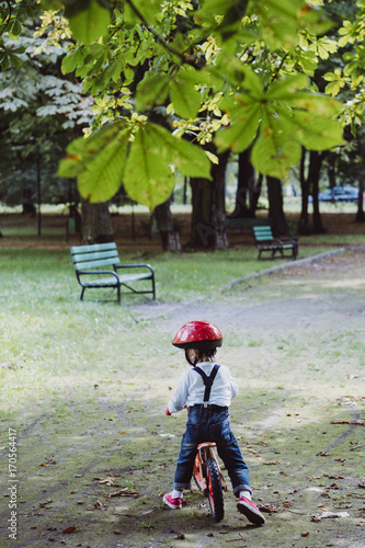 Fototapeta Naklejka Na Ścianę i Meble -  Boy on the bicycle in the city park.