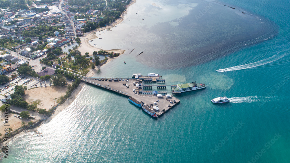 Aerial view of Koh Phangan international port with boats in the clear blue sea
