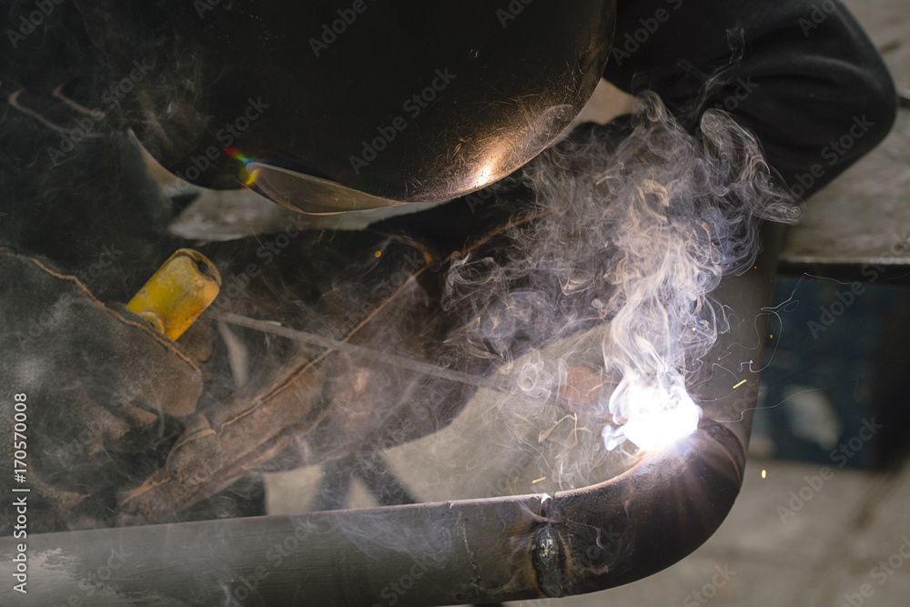 Naklejka premium welder welds pipes for gas installation