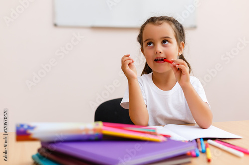 Little girl doing school work at home photo