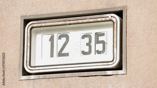 Old clock in the wall with turning figures