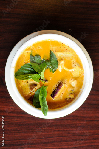 Red Curry, A delicate mix of red curry in coconut milk with eggplant, bamboo shoots, bell peppers and sweet basil leaves.