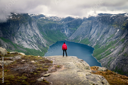 Obraz na płótnie Young female hiker enjoying beautiful view of dramatic landscape in a Norway