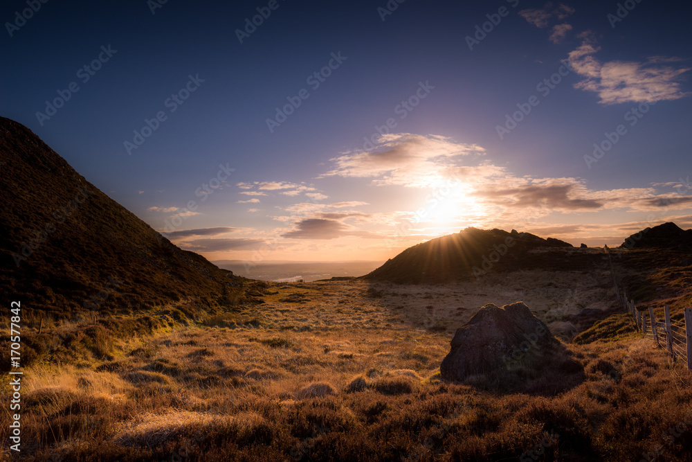 Fototapeta premium Little Mash under the Sunset Light: a quiet little Marsh in a cold windy place tries to warm up with the very last sunbeam of the day, Slievenaglogh, Dundalk, County Louth, Ireland