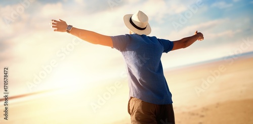 Billede på lærred Composite image of low angle of a man raising arms up
