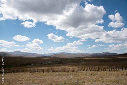 Wooden fence in the highlands and sky with clouds