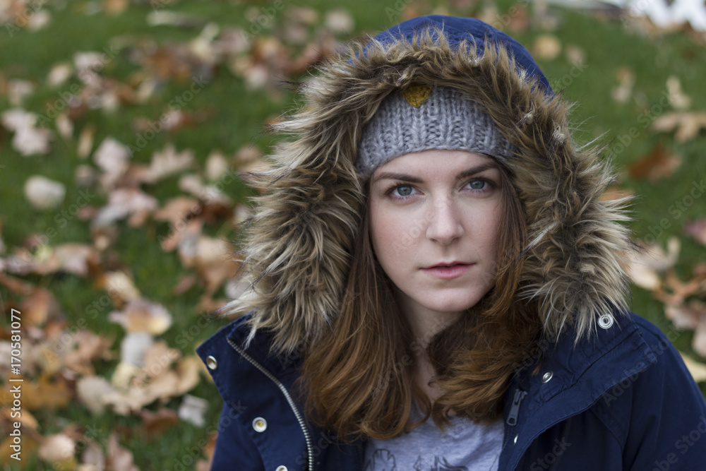 Portrait of a young woman wearing hood in autumn. Soft focus Portrait of a young woman wearing hood in autumn. Soft focus