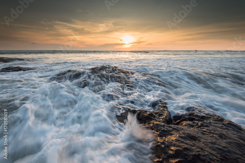 sea waves lash line impact rock on the beach