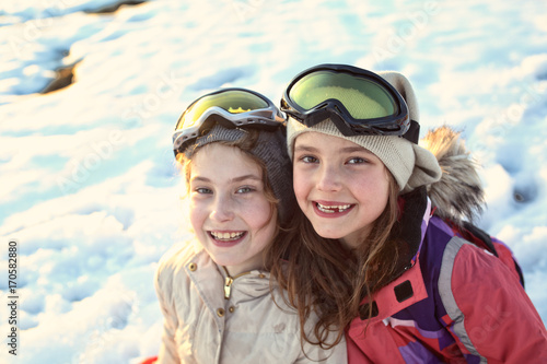 Young smiling girls play on a winter sunny day © ambrozinio