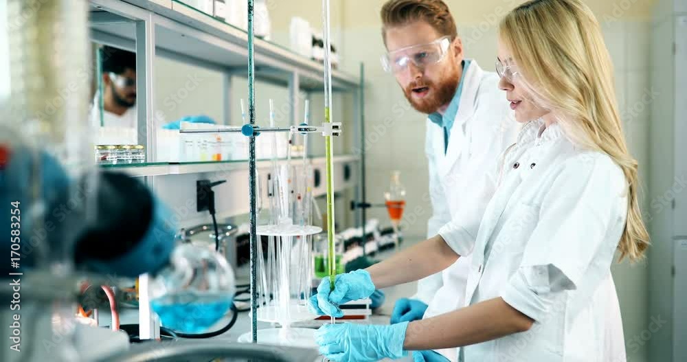 Young students of chemistry working in laboratory Young students of chemistry working in laboratory