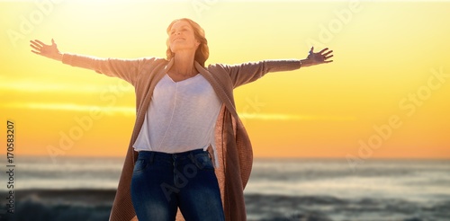 Tableau sur toile Composite image of a woman raise her arms up