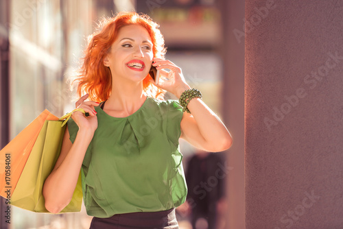 Smiling woman with shopping bags after shopping.