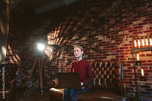 Woman with laptop in loft