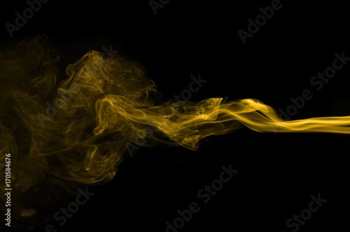 Gold smoke on black background,movement of gold smoke, Abstract gold smoke on black background, gold background,gold ink background,yellow smoke,Glittering gold smoke tail