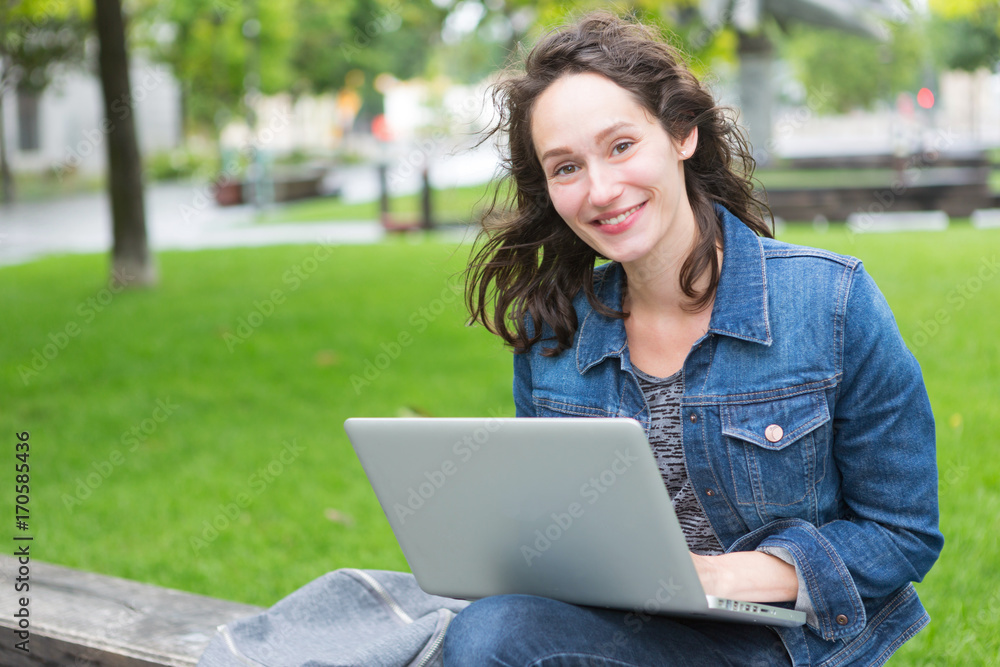 Portrait of a young student with backpack going to school and using her laptop - Technology and education concept Portrait of a young student with backpack going to school and using her laptop - Technology and education concept