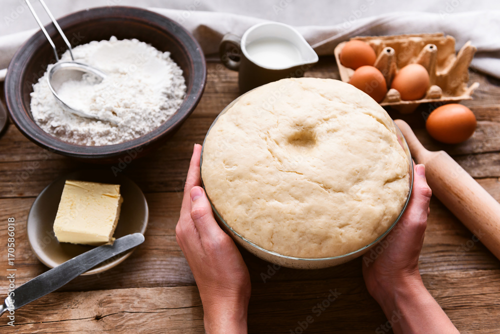 the cook makes dough next to the ingredients the cook makes dough next to the ingredients