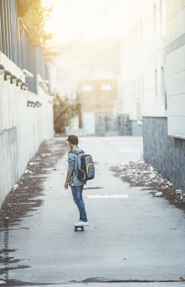 Young man with backpack and skateboard Young man with backpack and skateboard