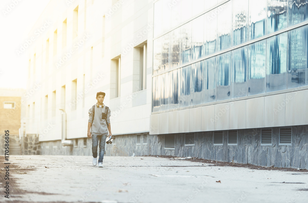 Young man with backpack and skateboard Young man with backpack and skateboard