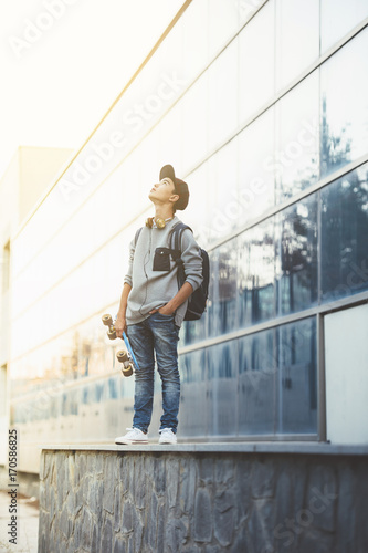 Young man with backpack and skateboard